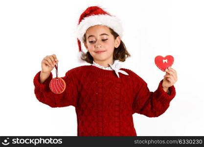 Adorable little girl wearing santa hat with Christmas biscuits isolated on white background. Winter clothes