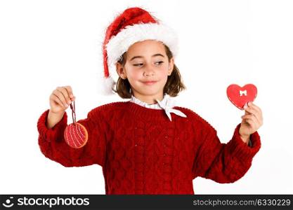 Adorable little girl wearing santa hat with Christmas cookies isolated on white background. Winter clothes