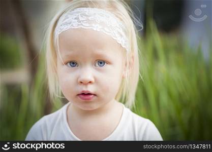 Adorable Little Girl with Blue Eyes Portrait Outside.