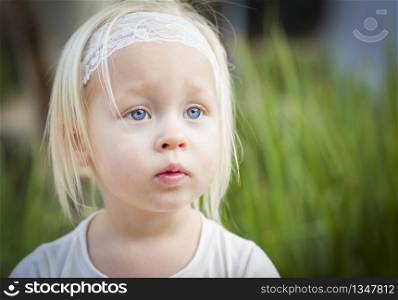 Adorable Little Girl with Blue Eyes Portrait Outside.