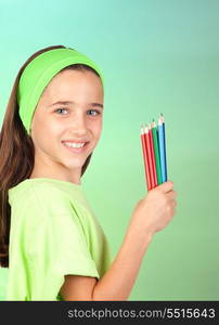 Adorable little girl with many colored pencils isolated on green background