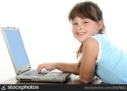 Adorable little girl working on laptop computer.