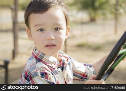 Adorable Mixed Race Young Boy Playing on the Tractor at the Pumpkin Patch.
