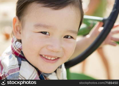 Adorable Mixed Race Young Boy Playing on the Tractor at the Pumpkin Patch.