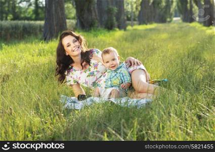 Adorable mom realxing with her cute baby son