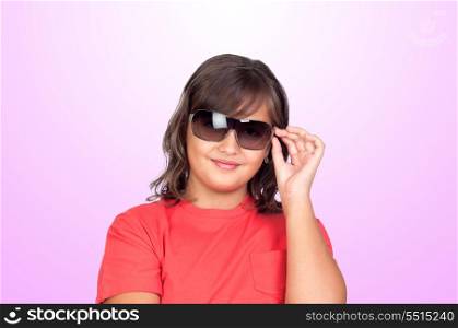 Adorable preteen girl with sunglasses isolated on pink background