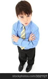 Adorable seven year old french american boy in slacks, dress shirt and tie over white background.