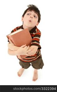 Adorable seven year old french american boy standing with large book over white background.