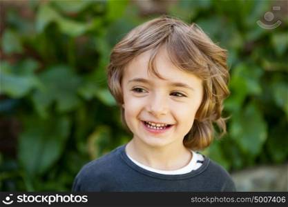 Adorable small child in the field looking at camera