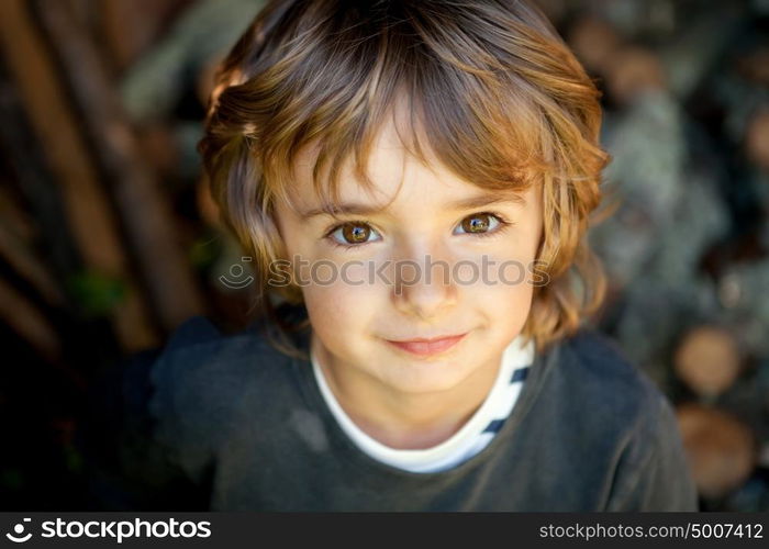 Adorable small child in the field looking at camera