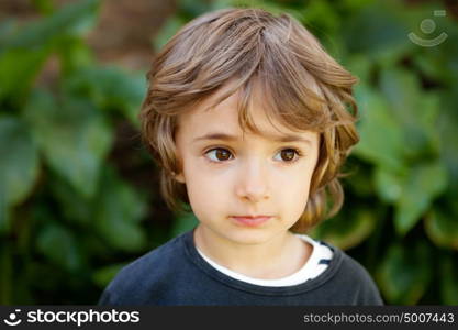 Adorable small child in the field looking at camera
