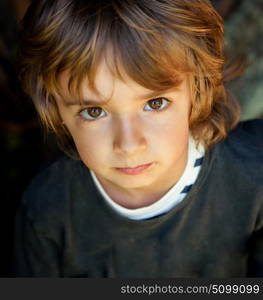 Adorable small child in the field looking at camera