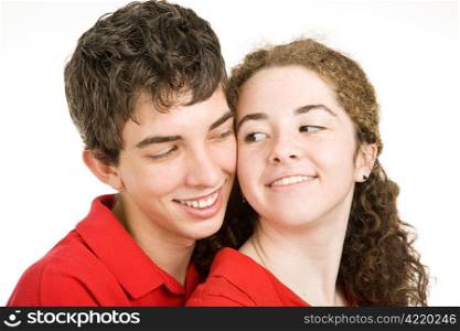 Adorable teen couple flirting with eachother. Isolated on white.