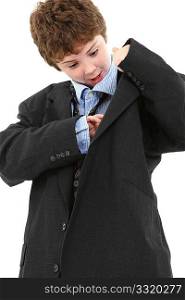 Adorable ten year old american boy in baggy blue suit looking in jacket pocket over white background.