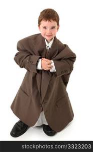 Adorable three year old boy in over sized suit over white.
