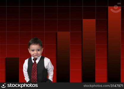Adorable Toddler Boy In Suit Standing Against Bar Graph. Hands in pocket and a sweet smile.