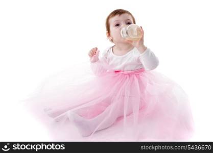 Adorable toddler girl is drinking isolated on white