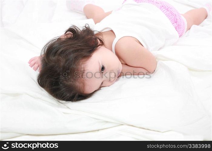 adorable toddler girl on the bed at home