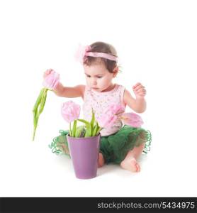 Adorable toddler girl with pink tulips, isolated on white