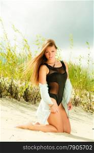 Adorable woman female model in full length posing outdoor on grassy dunes
