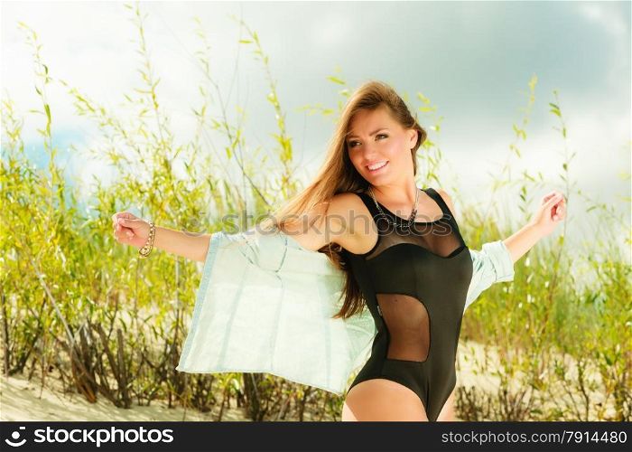 Adorable woman female model posing outdoor on grassy dunes