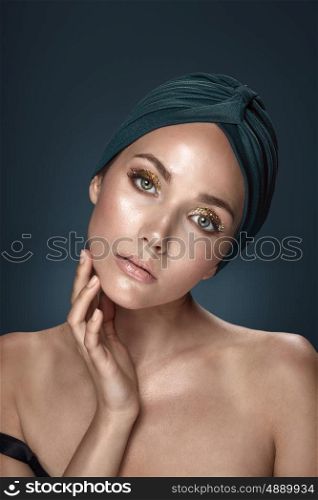 Adorable woman wearing a green headscarf