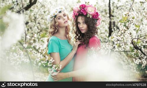 Adorable women in the fragrant orchard