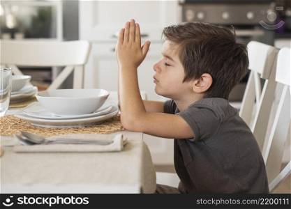 adorable young boy praying home
