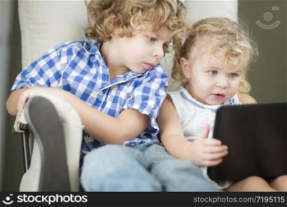 Adorable Young Brother and Sister Using Their Computer Laptop Together.