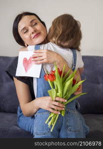 adorable young girl hugging her mother