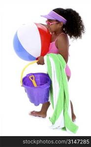 Adorable Young Girl Ready for the Beach. With sun visor, sunglasses, beach ball and towel.