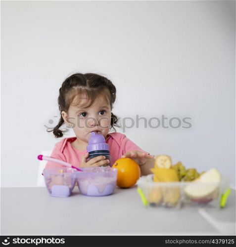 adorable young girl with fruit bowl