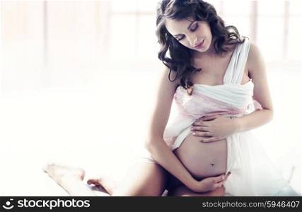 Adorable young mother in pregnancy