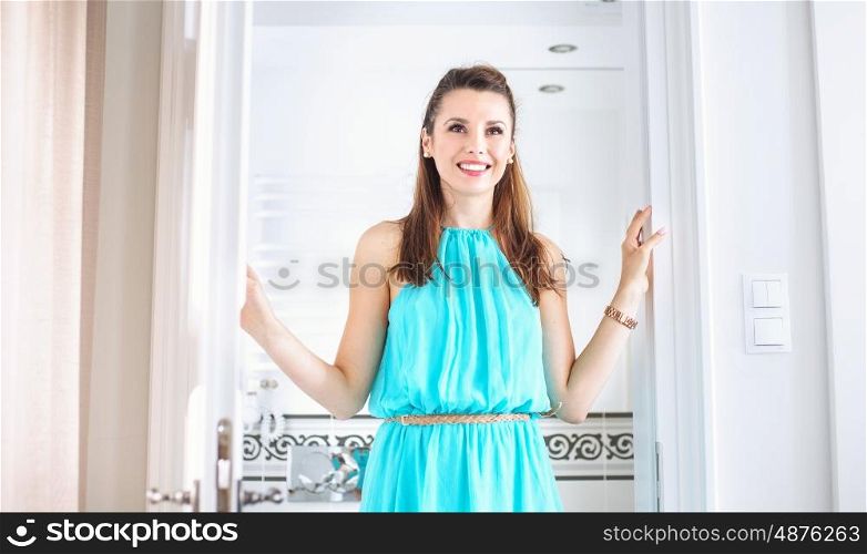 Adorable young woman in her bright bathroom