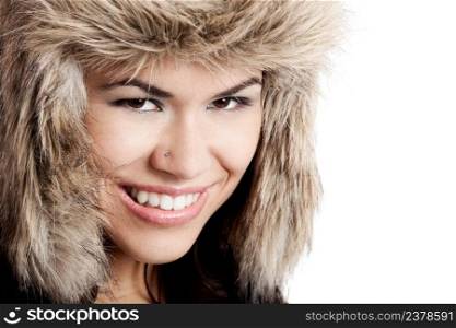 Adorable young woman smiling with a fur hat