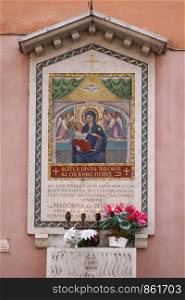 Adorned altar on street in Italian Madonna asks for help