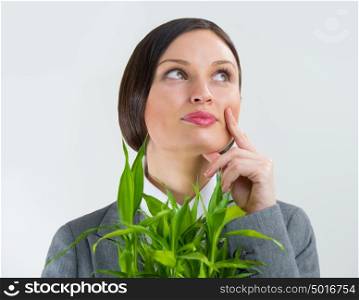 Adult business woman holding lucky bamboo plant symbol of success. Business growing concept