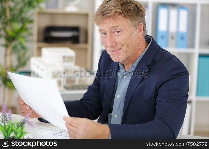 adult businessman in suit is laboring with concentration