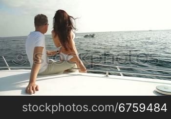 Adult Couple Relaxing on a Speedboat, Rear View