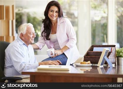 Adult Daughter Helping Father With Laptop