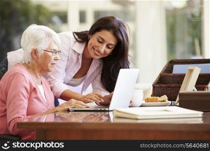 Adult Daughter Helping Mother With Laptop