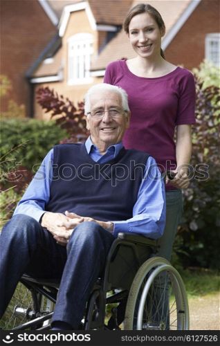 Adult Daughter Pushing Father In Wheelchair