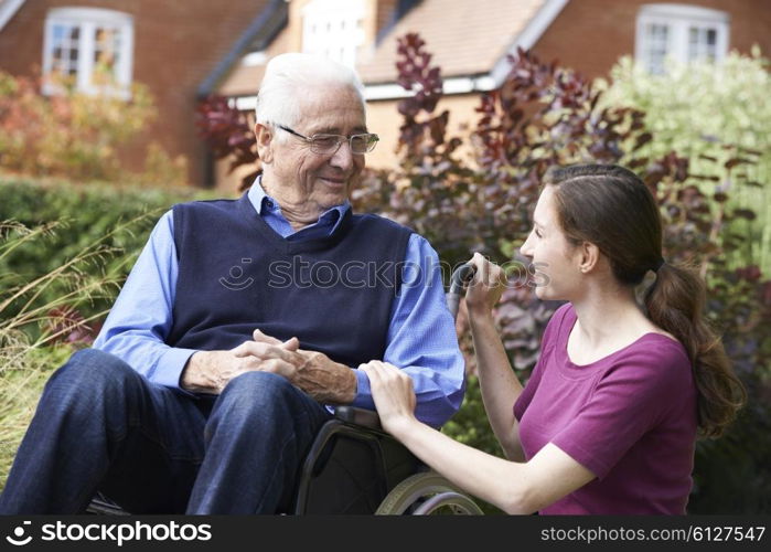 Adult Daughter Visiting Father In Wheelchair