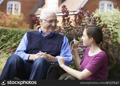 Adult Daughter Visiting Father In Wheelchair