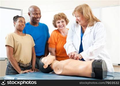 Adult education class, teaching first aid CPR using a state of the art doll.