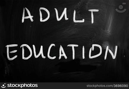 ""Adult Education" handwritten with white chalk on a blackboard"