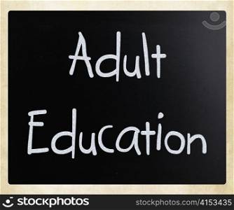 ""Adult Education" handwritten with white chalk on a blackboard"