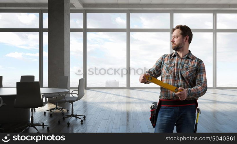 Adult engineer man. Builder man in checked shirt with tool belt on waist. Mixed media