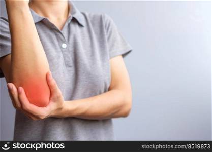 adult female with her muscle pain on gray background. Woman having elbow ache due to lateral epicondylitis or tennis elbow. injuries and medical concept
