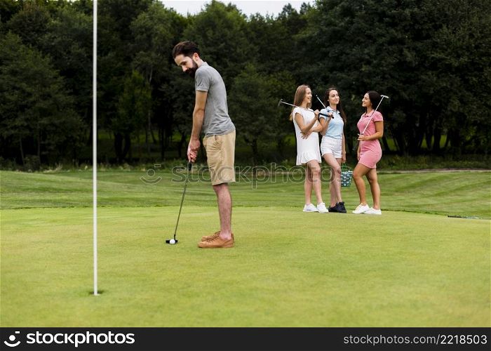 adult fit man training golf outdoors